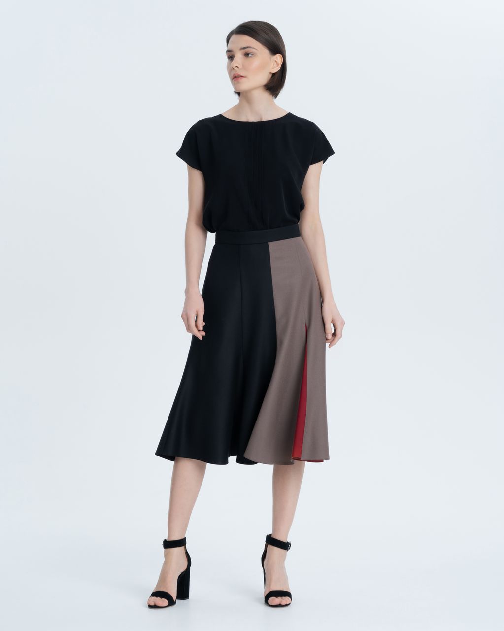 Asymmetric skirt made of premium Italian wool with a thin viscose lining. The combination of black, coffee and delicate dark red accents will allow you to combine the skirt with various things in your wardrobe.