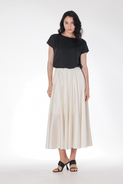 A flying, flowing satin skirt can be combined with a basic T-shirt or top, as well as a more complex top.