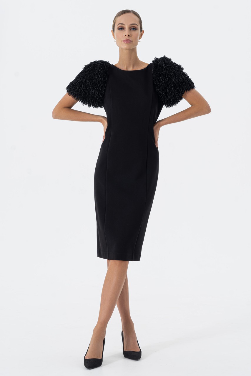 Evening dress with volumetric, textured sleeves made of thick jersey with a scoop neckline on the back and a slot on the middle seam.