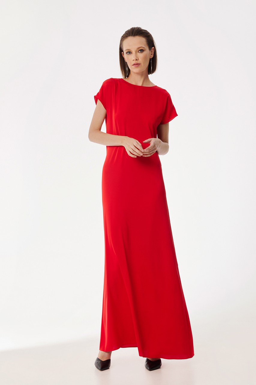 Flying floor-length dress with dropped sleeves and an open back trimmed with decorative lacing.