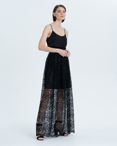 Evening double skirt. The lower layer and belt are made of black satin, and the upper layer is made of textured black lace with delicate sequins and an openwork edge at the bottom of the product.