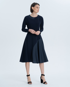 Minimalistic crepe dress with geometric inserts made of fine costume wool with a small pattern. Delicate neckline, fitted silhouette and elegant one-piece sleeve.