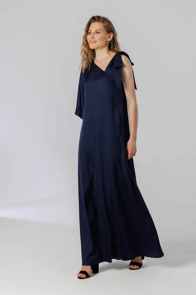 Flying assymetrical maxi dress with a flared sleeve and one opened shoulder with ribbon straps tied into a bow.