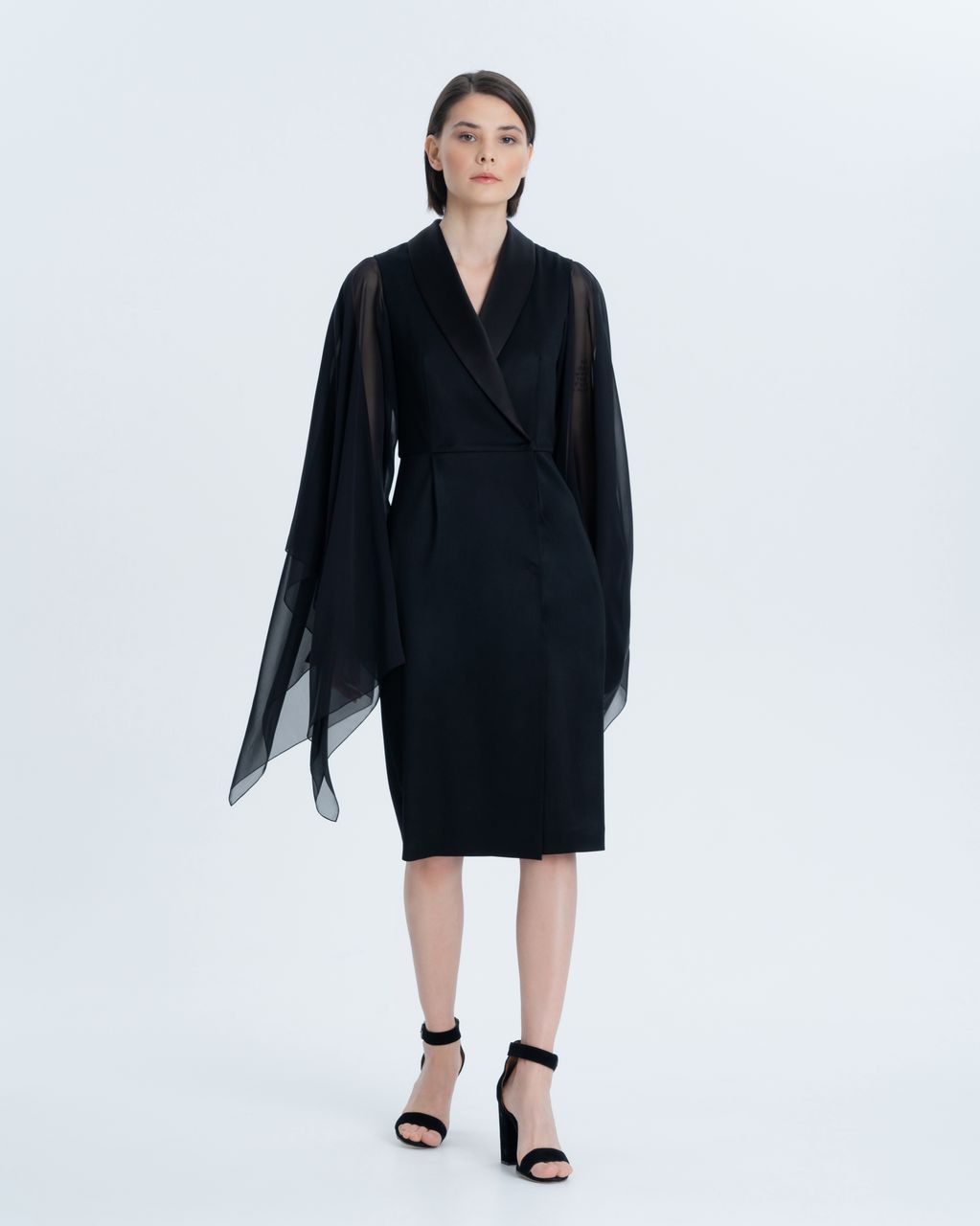Tuxedo dress made of premium Italian suit wool with silk chiffon wing sleeves. The lapel of the dress is trimmed with thick satin, and a double-breasted clasp on tight sewn buttons, which gives the image a special chic. For your comfort, the dress is