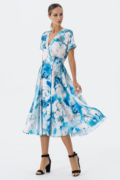 A fitted satin dress with an author's artistic watercolor print with a flowing skirt. One-piece cuff sleeves, plackets and a wrap closure are details that add charm and sophistication to this model.
