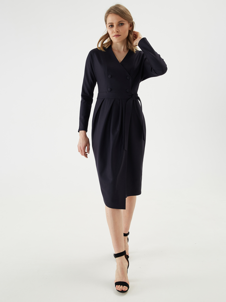 Elegant double-breasted asymmetrical dress in premium suiting wool with viscose lining. One-piece sleeve, fastening with tight-fitting buttons — details that fill the image.